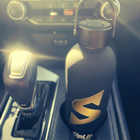 SipLift Signature Hydration Flask sitting in car cupholder